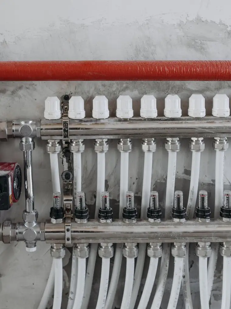 A clean chrome and copper supply manifold on a fresh repipe