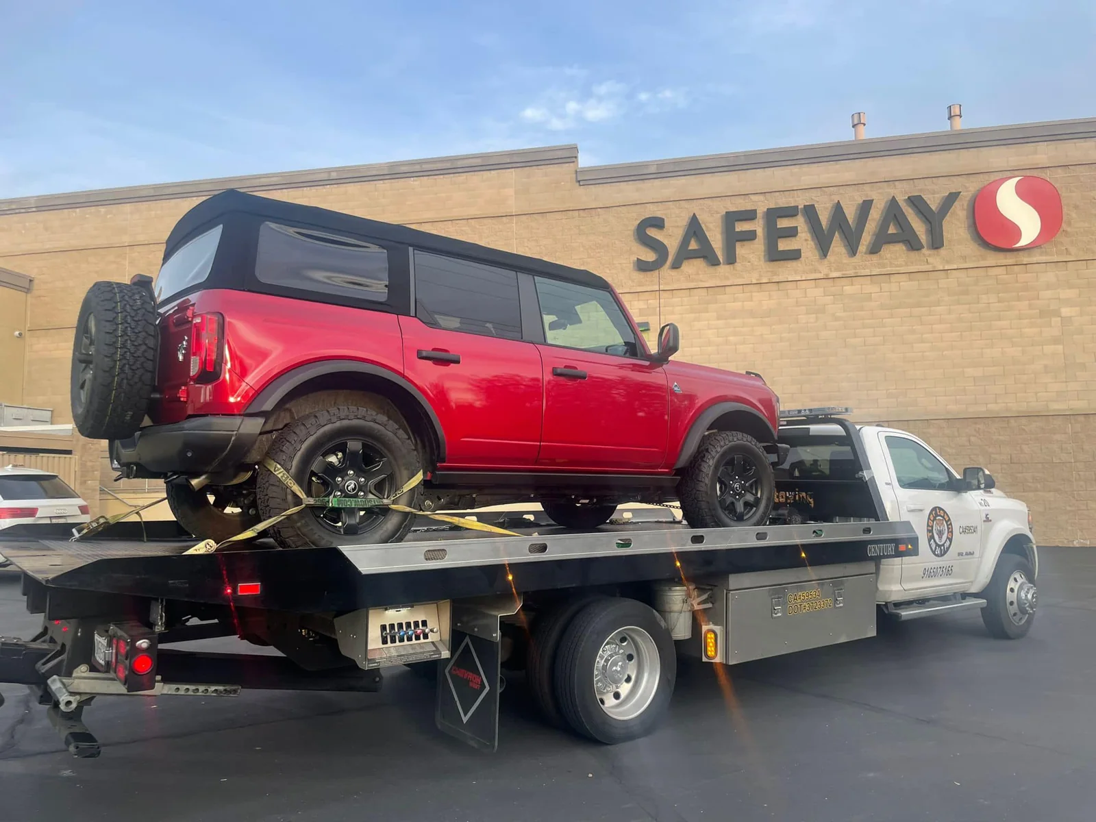 Red SUV on a Tiger flatbed