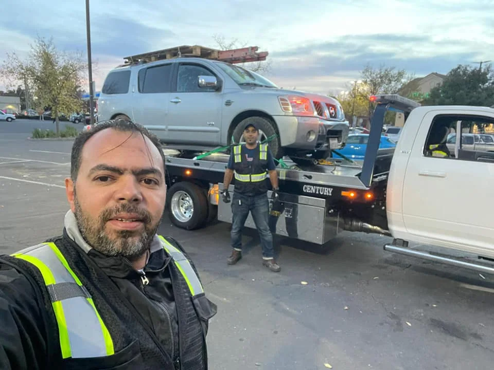 A Tiger Towing team member beside the truck